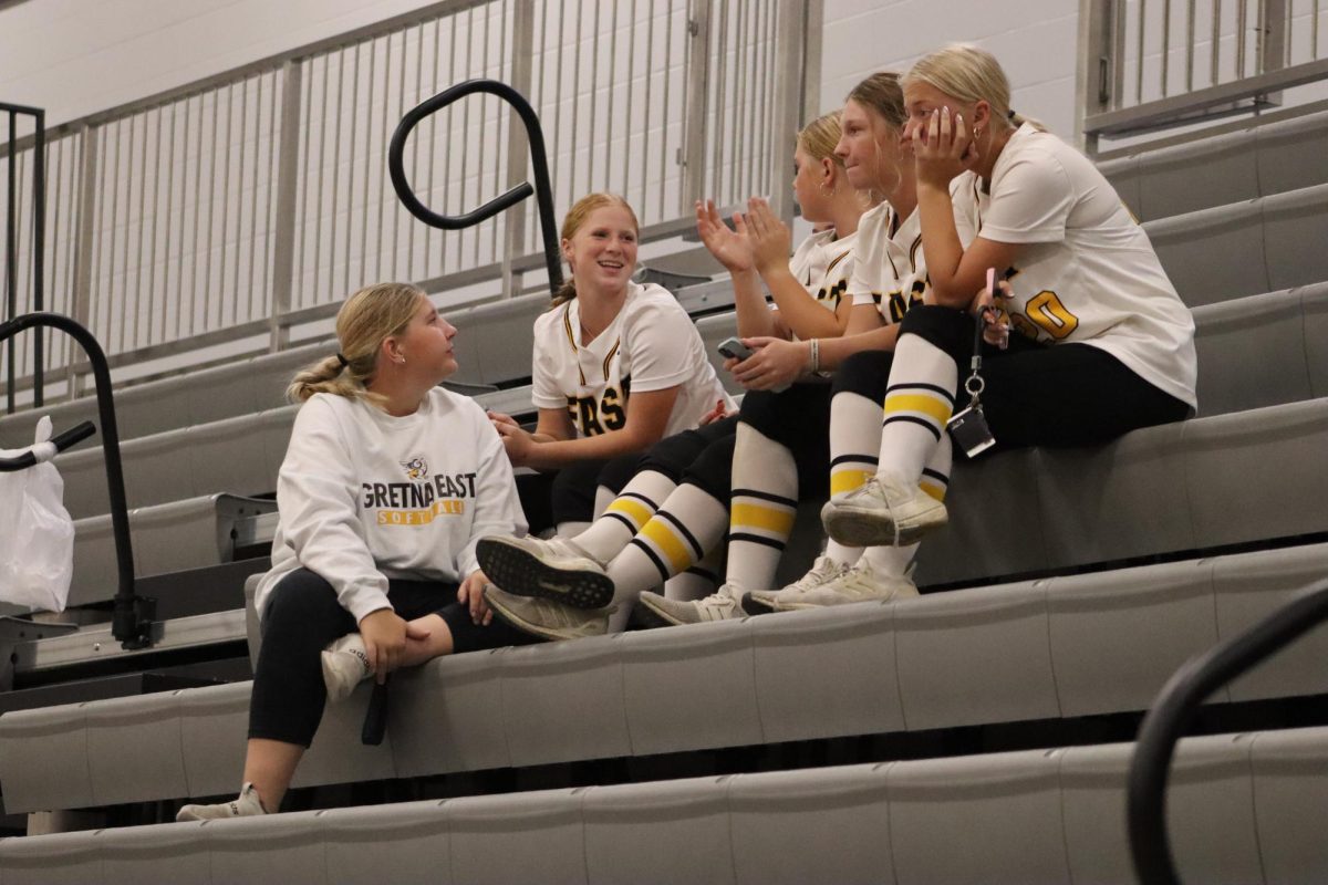 Enjoying the game, varsity softball players converse after their practice on Sept. 19.  