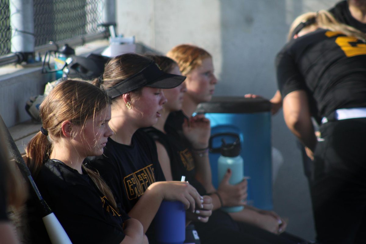 Before the game, the Griffins hydrate and cool down in the dugout. 