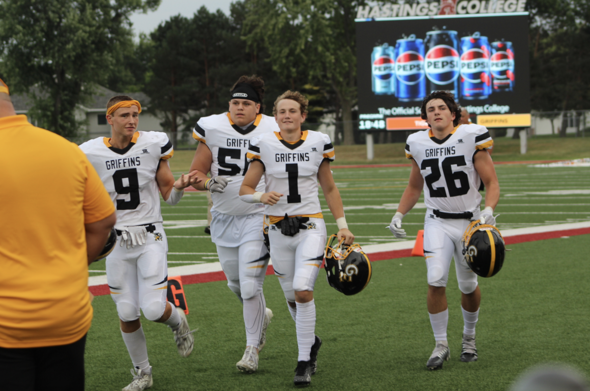 Jogging back to the huddle captains Luke Johnson (11), Kaehle Toledo (11), Grayson Fisher (11) and Connor Sams (10) inform the team that they are kicking.