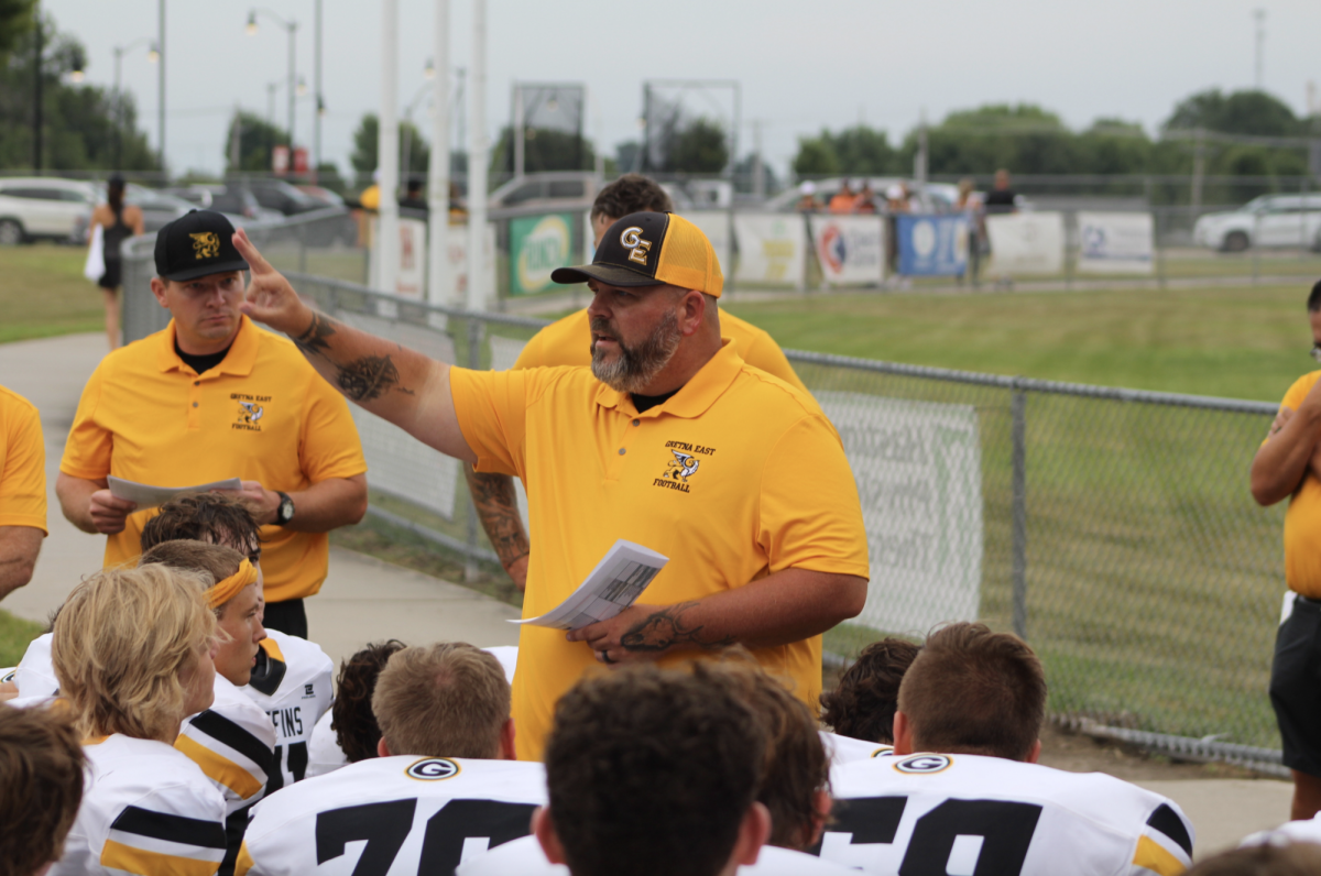 In the pregame huddle coach Shawn Blevins gives the team a hype-up speech.
