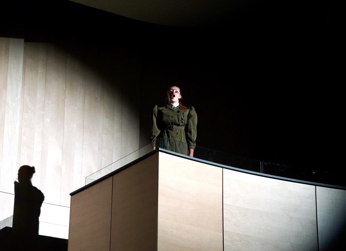 Making a surprise entrance, Trunchbull appears on the balcony of the theater.