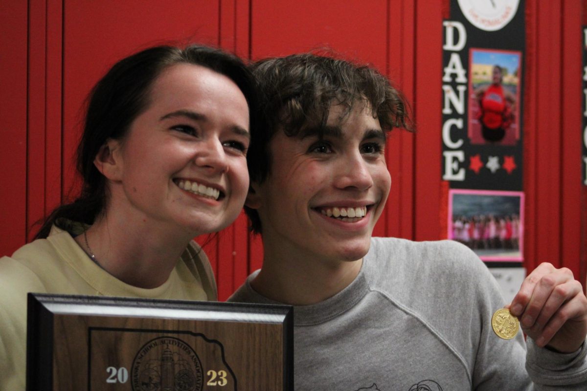 Before leaving the competition, Nicole Schlautman and Colton Knott (11) hold up the Districts award and coin for the Outstanding Male Performer award.
