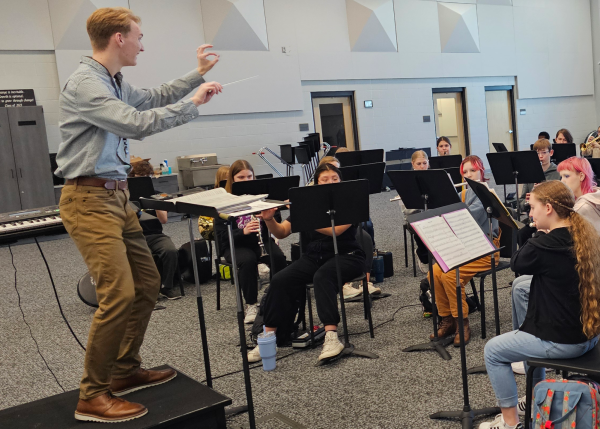 Directing his first period band class, student teacher William Holke has students play Lightning Field. He had students play different notes by section as the class came to a close. 