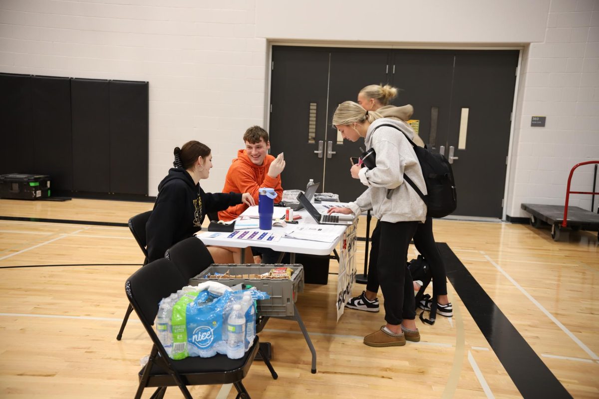 While checking donors in, juniors Jackson Windeknecht and Maggie Pfaff laugh.