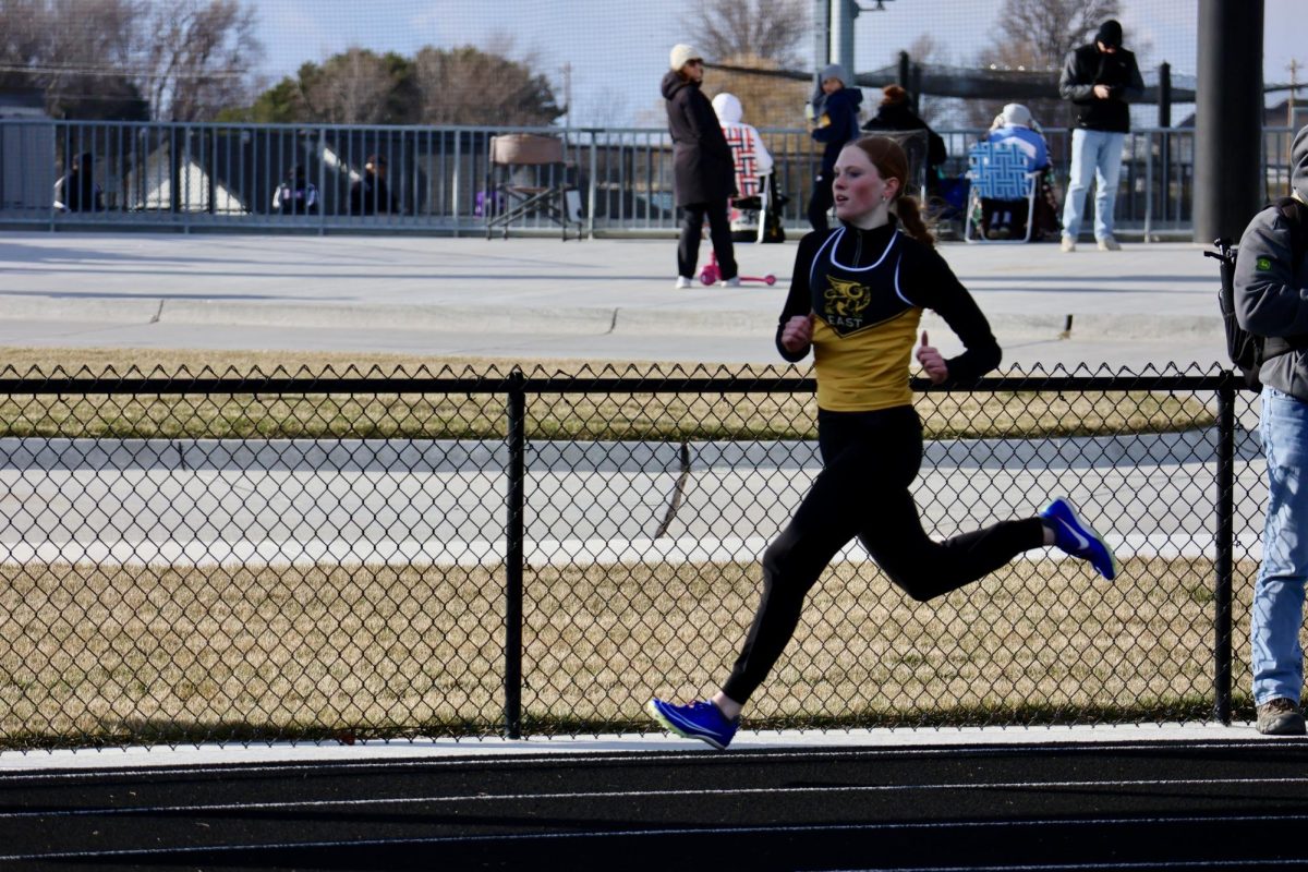Running the 400m, sophomore Madisyn Clarke Wisnieski takes off and starts sprinting the first curve of her race. 