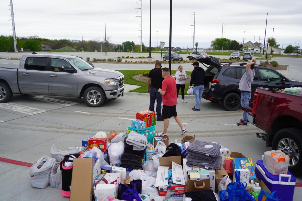 Donations piling up, the football boosters collect more items from donors.