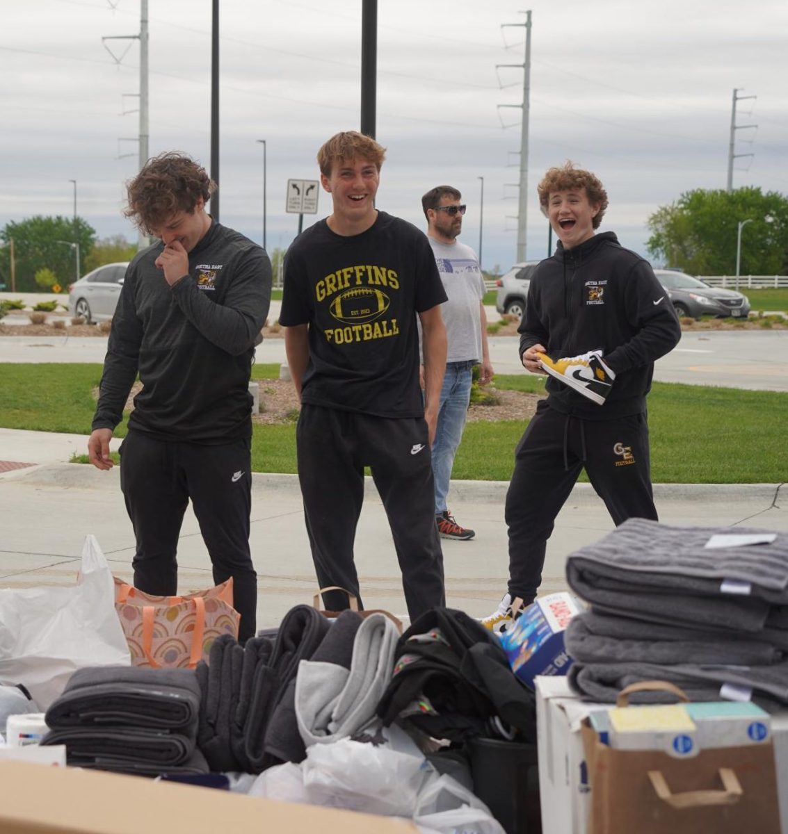 Helping to load the cars full of donations toward the end of the drive, juniors Mason Gunn, Joseph Costanzo and Grayson Fisher laugh. 