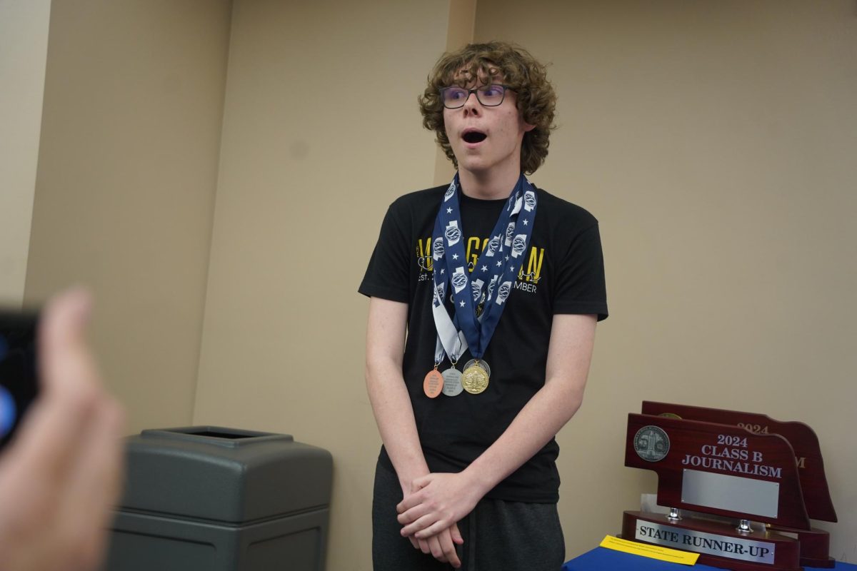 Realizing he received first place, sophomore Brayden Hansen looks at the Gretna East Media team in shock. 