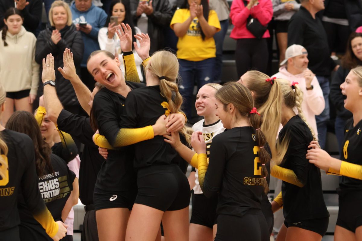 Embracing after their game on Oct. 28, juniors Stella Stockstill and Nyah Potoff jump surrounded by the team. 