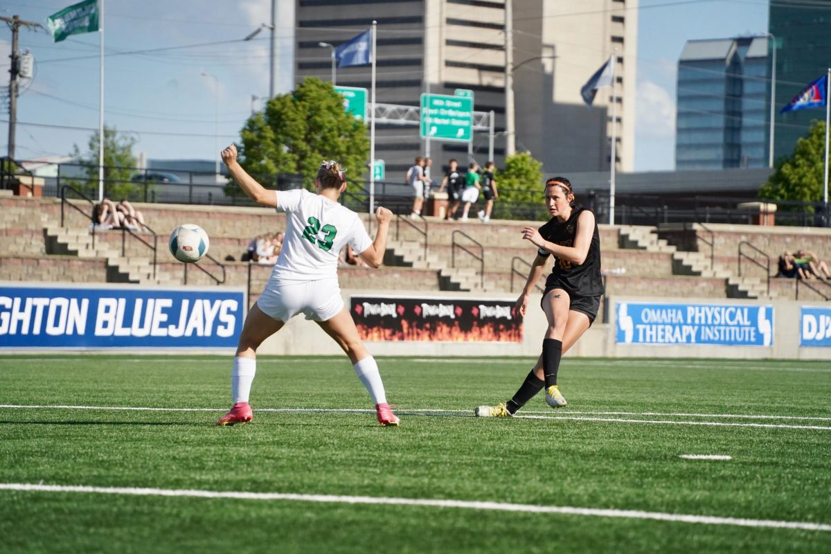 Kicking past a Scotus player, junior Sonora DeFini takes a shot at the goal. She did not make it.