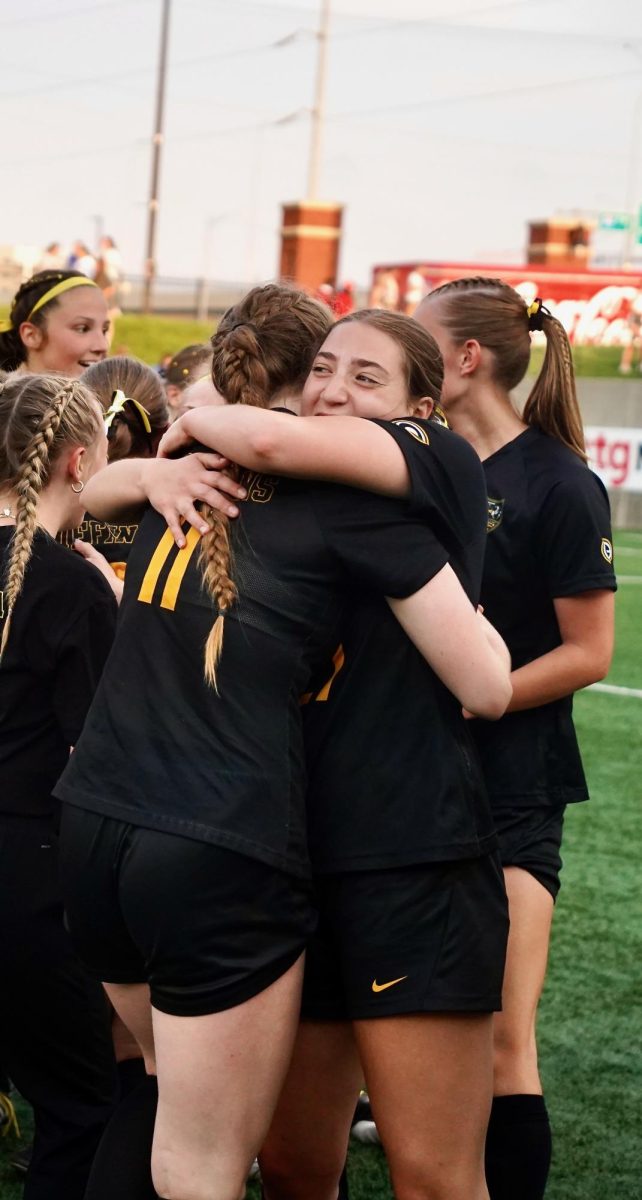 Among celebrating teammates, sophomores Addyson Moore and 