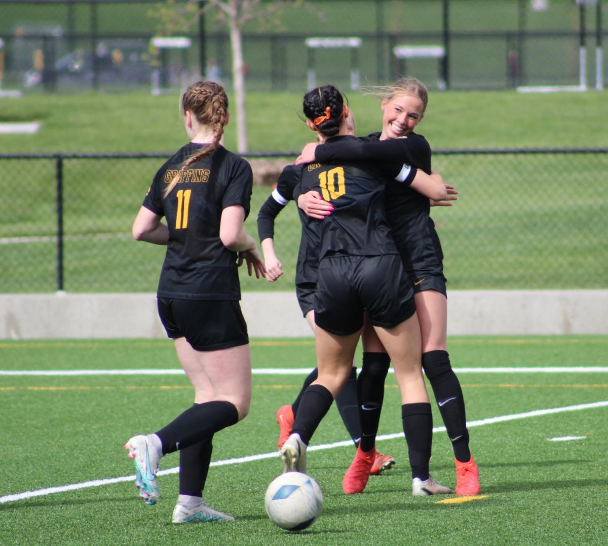 After junior Senora DeFinis successful goal, with assist from junior Kendall Dobberstein, the pair embraces. 