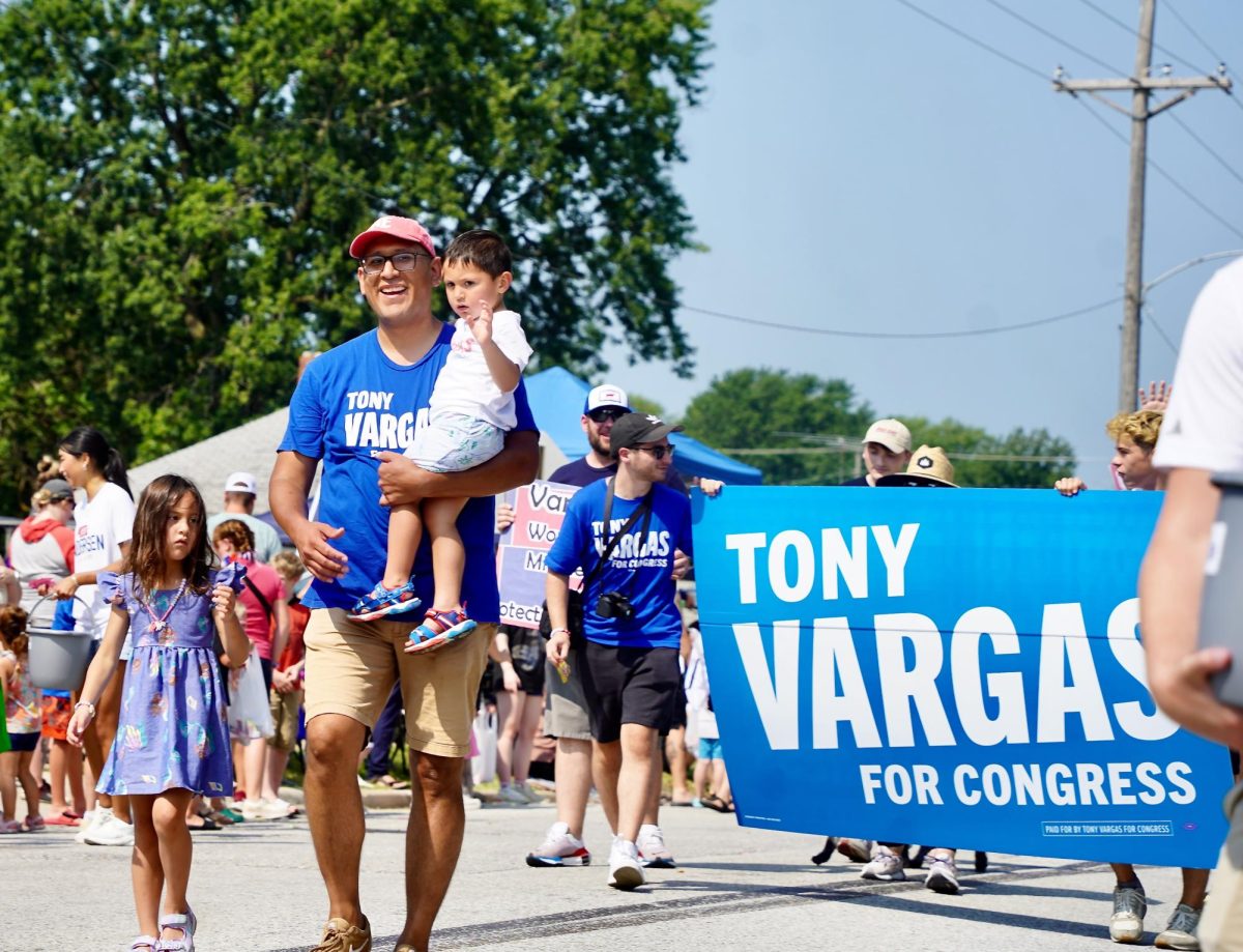 With his children in tow, Nebraska Senator Tony Vargas walks the parade. Other politicians and public officials led groups with campaign signs as well.  