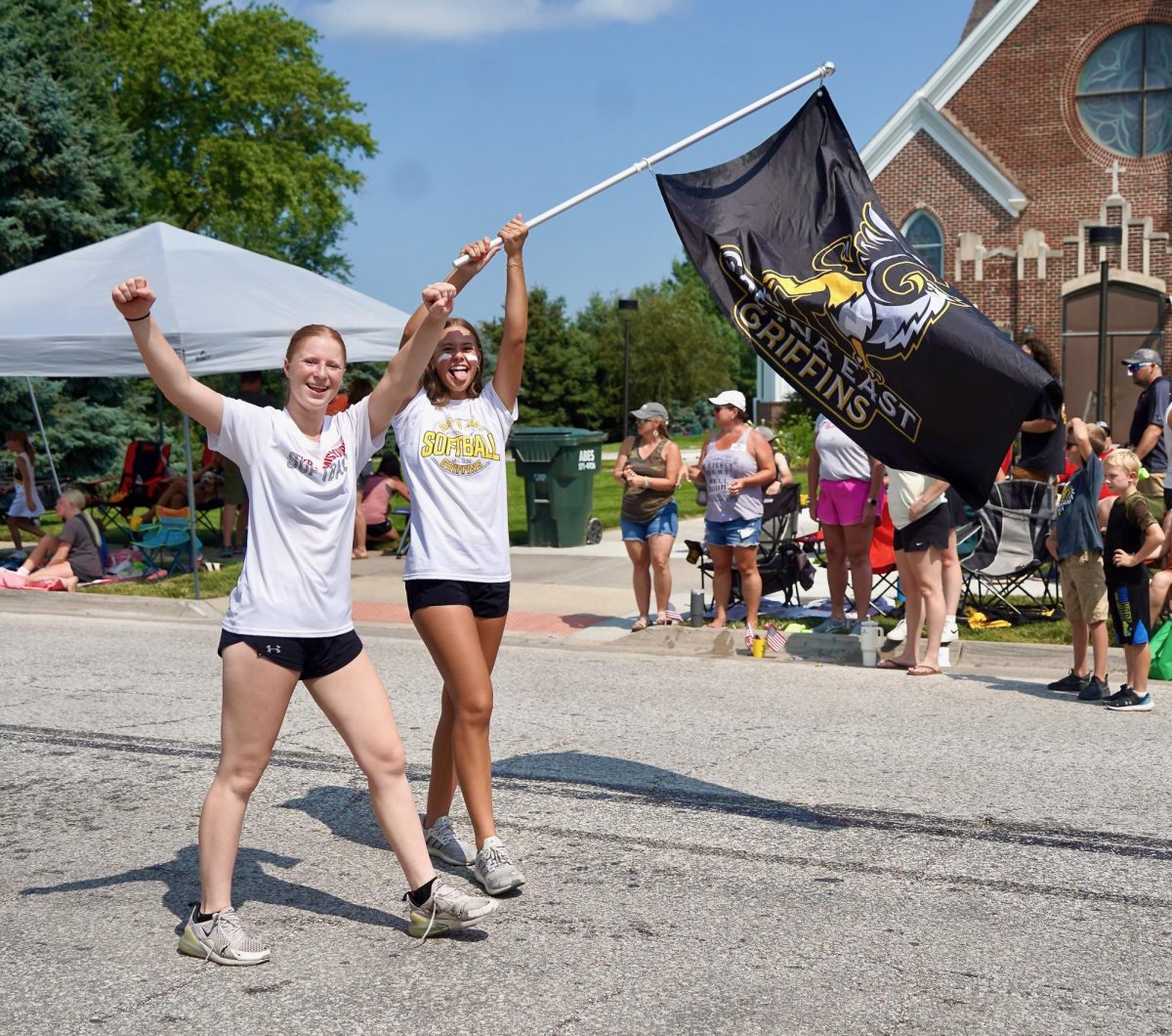 Proudly displaying the GEHS flag, sophomores Amanda Weis and Kaylin Hinerman follow the GEHS softball float. 