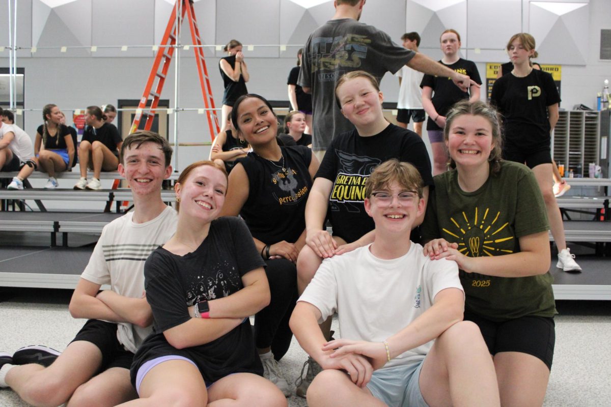 Sitting in their “family groups”, juniors Easton Roarty, Ava Fink, Elisha Toledo and Madelynn Baker-Klassen and sophomores Riley Critser, Taryn Stastny, act like scientists in their second number, “Thomas Edison/Weird Science.