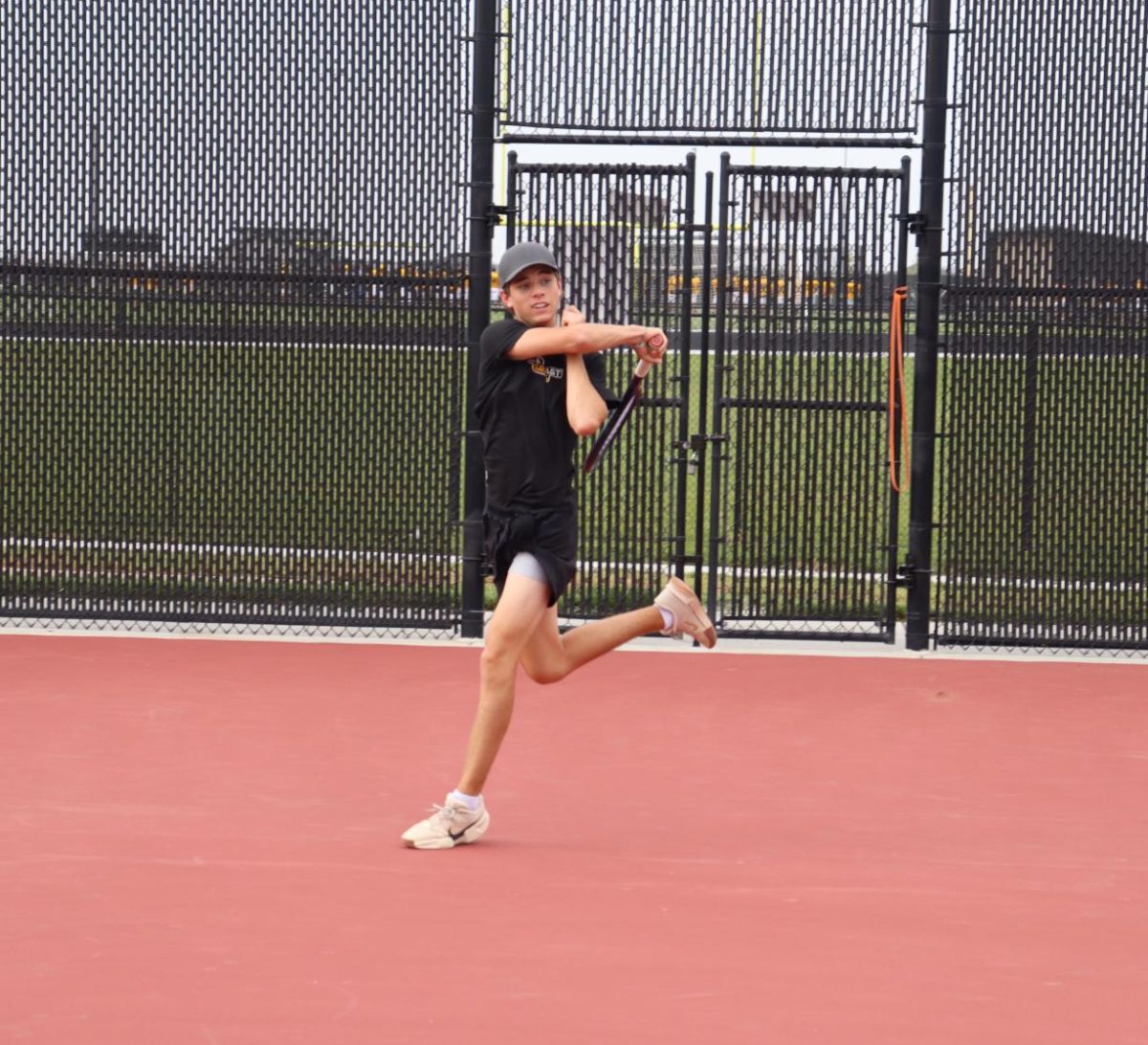 Lunging to save the ball, senior Braden Dall uses his forehand to return the ball. Dall won his double's match with Gilliand 8-1.