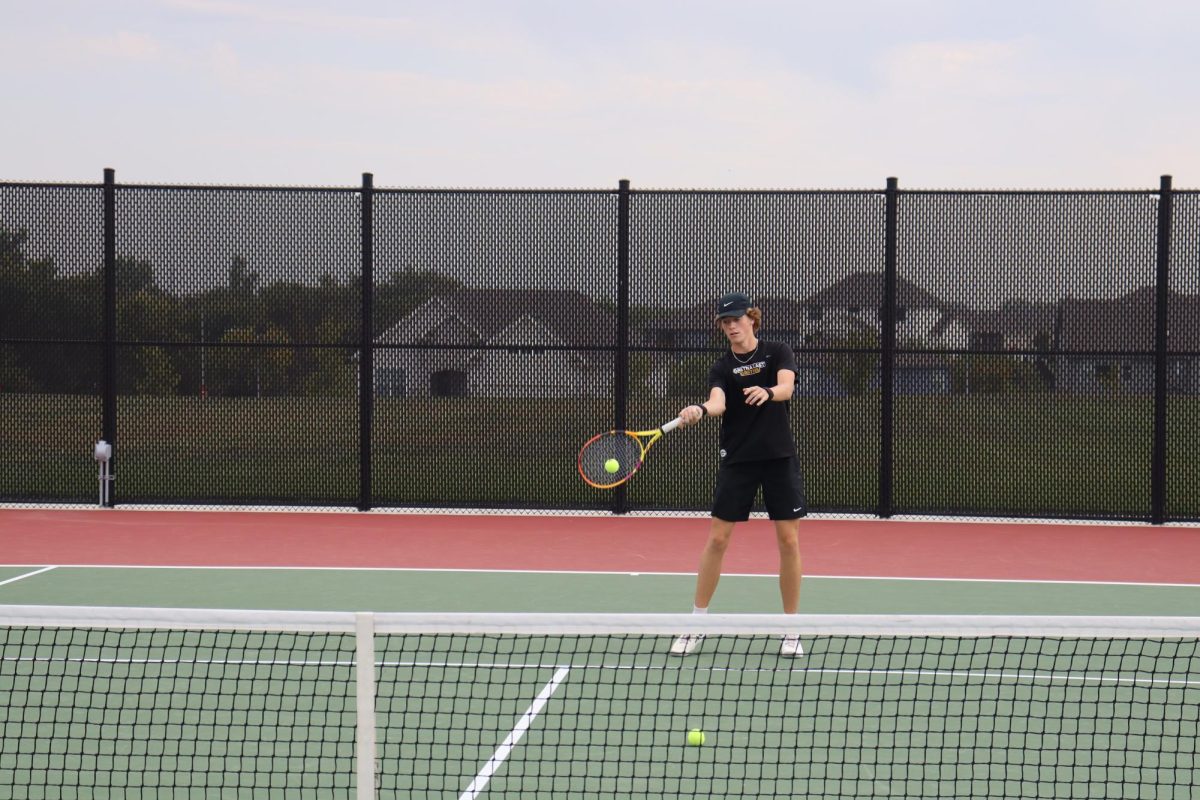 Getting ready to beat his opponent, senior Rylan Wobken works on his underhand hits. Wobken went on to sweep his opponent 8-0.