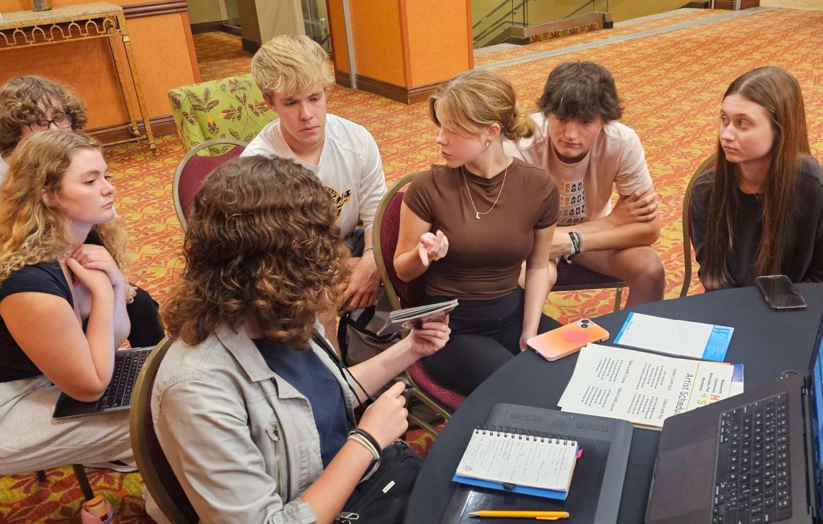 At the Walsworth Yearbooks fall workshop on Sept. 16, the yearbook editorial board works with cover artist Lauren Kellam to pick out materials and make a mock-up of the 2025 yearbook cover. 