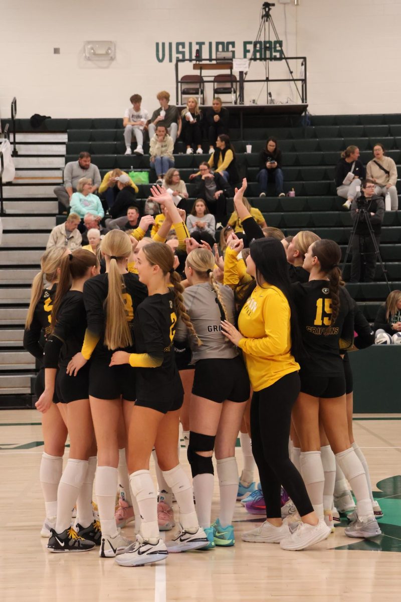 Before the game begins, the Griffins huddle up and wish each other good luck with a group high five. 