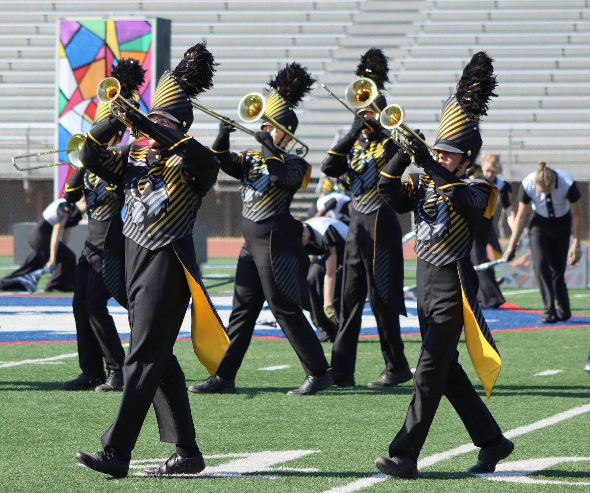 Playing loud and proud, senior Charles Morgan leads his fellow trumpets in their preliminary performance at the Omaha Marching Invitational on Oct. 19. 