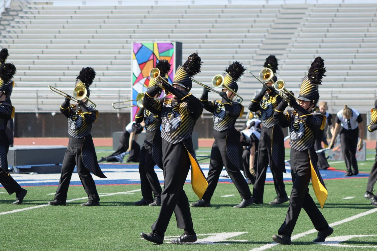 Playing loud and proud, freshman James Emmons leads his fellow trumpets in their preliminary performance at the Omaha Marching Invitational on Oct. 19. 