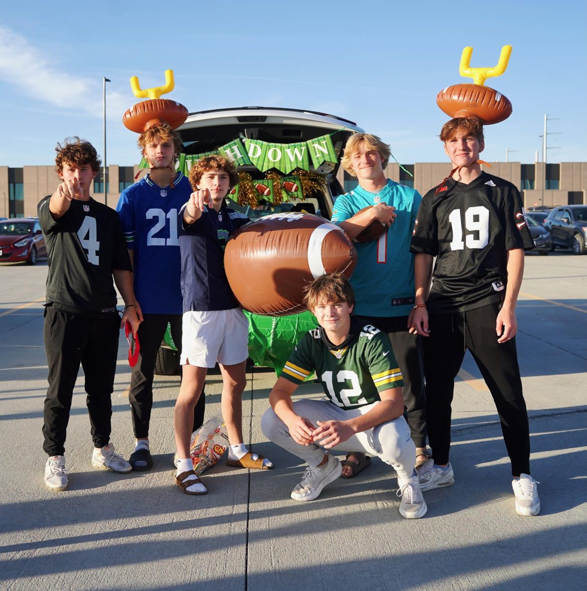 Posing for the camera, juniors Jaxon Godfrey, Carson Hermann and Seth Kragel, along with seniors Braxton Steenbock and Joseph Costanzo show off their football themed decor and outfits.