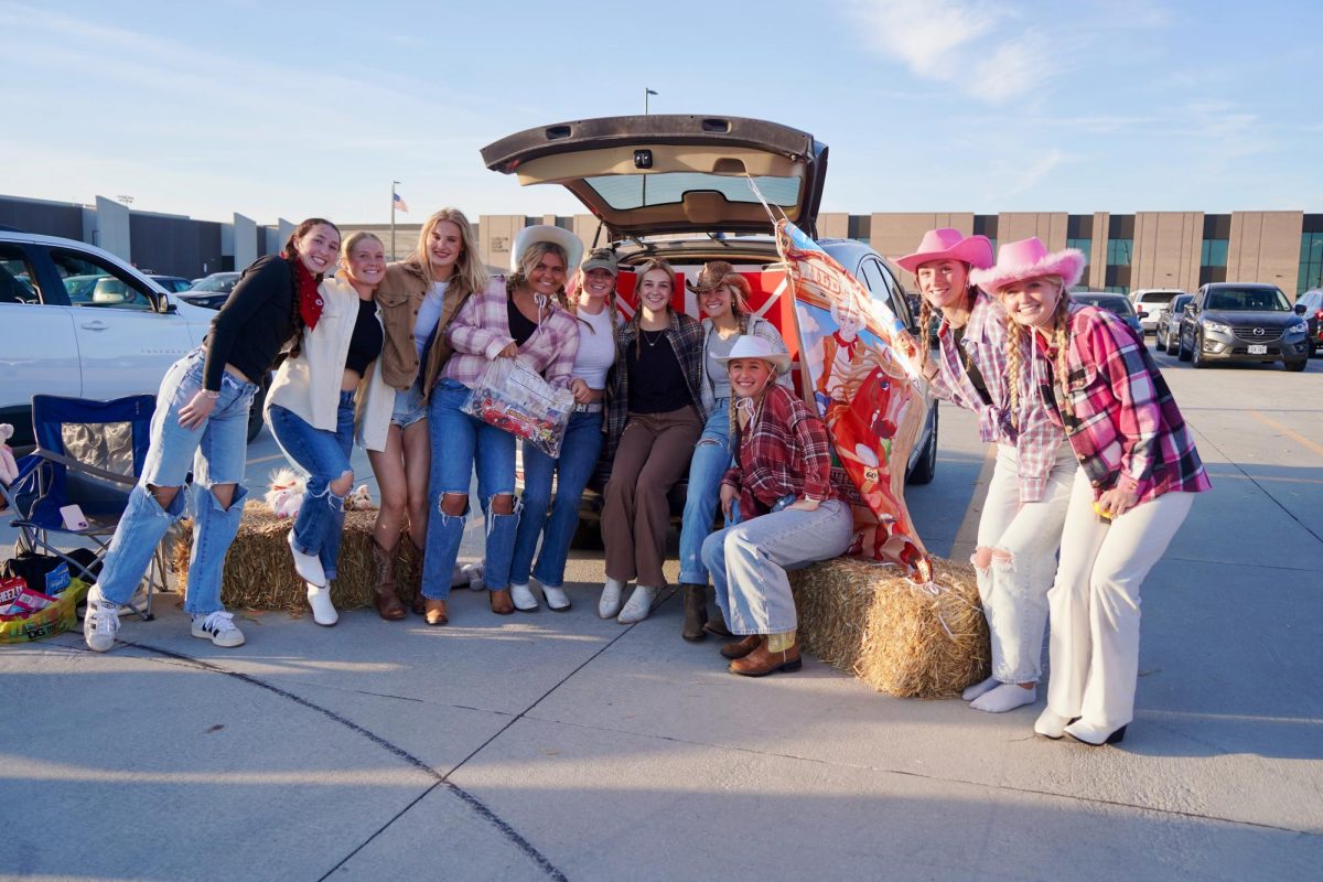 Dressed for their western theme, a group of junior girls pose for a picture. The trunk also featured a game where Trunk-or-Treaters threw a bean bag at targets. 