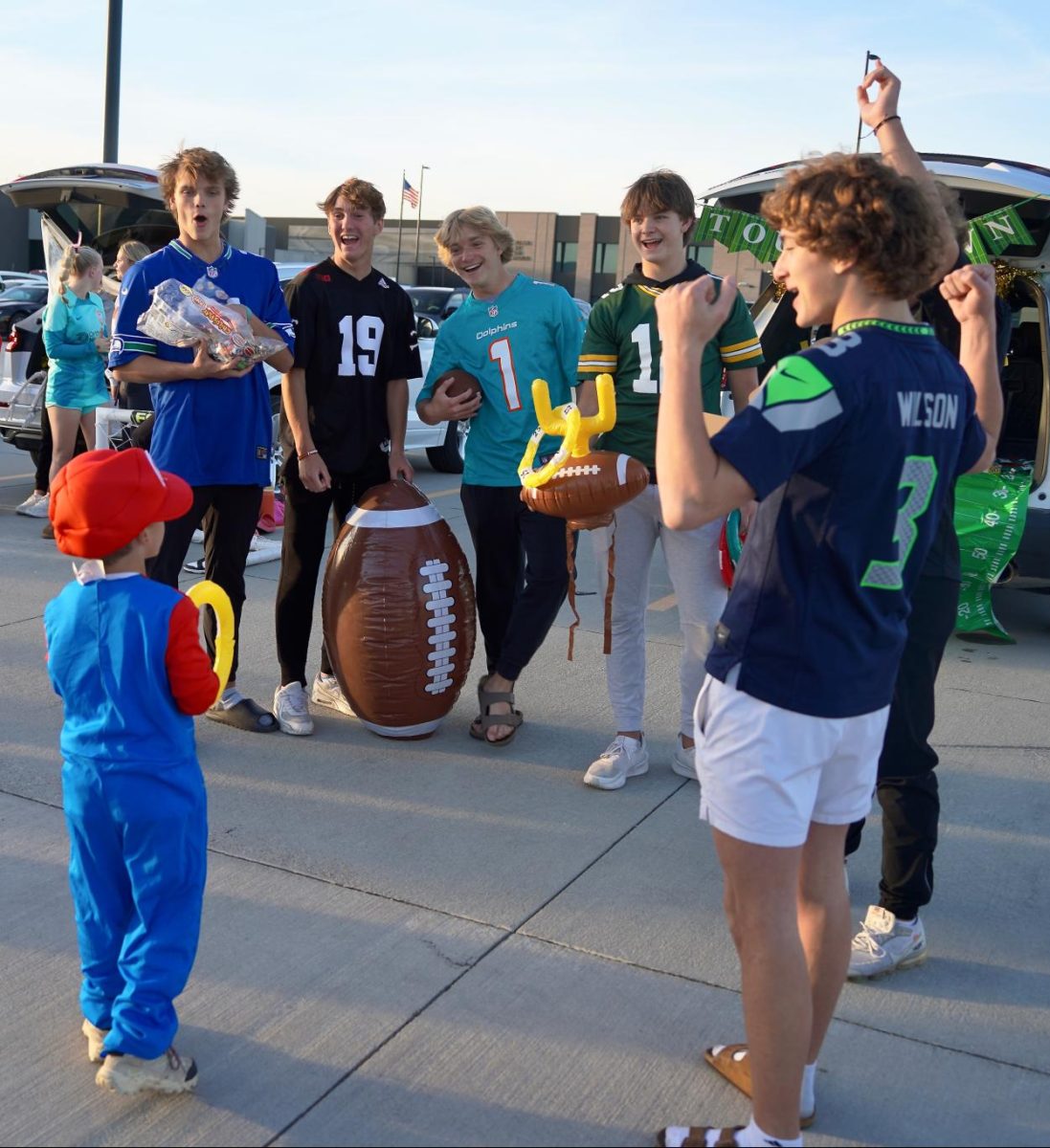 Cheering on a participant, the football themed bunch watches as he attempts to throw a ring onto the target. Despite the game, the group gave out handfuls of candy regardless if the Trunk-or-Treater hit the target.