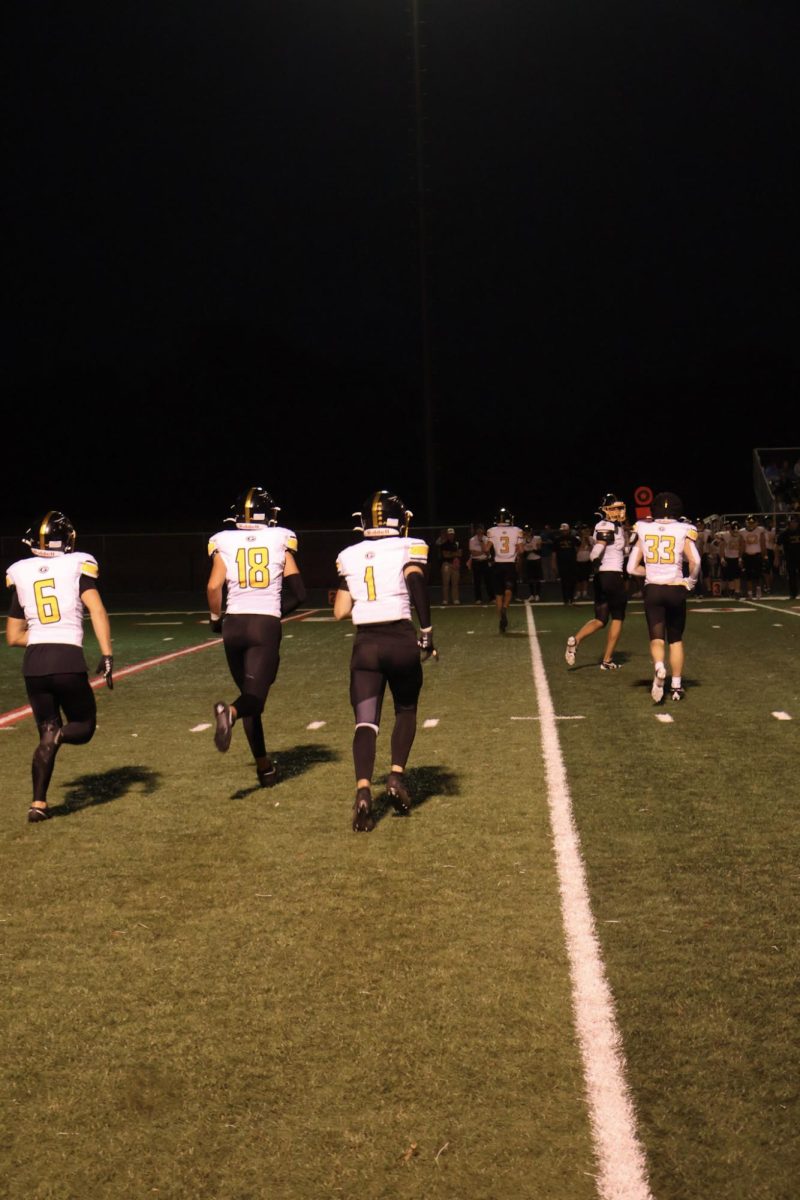 Preparing to hold their ground, the Griffin defense heads out onto the field lead by senior, safety Greyson Fischer.