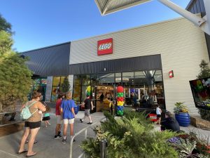 Standing in line, prospective customers wait for their turn to enter the Lego store on Friday, Sept. 20. The store is located between Vineyard Vines and Famous Footwear at the Nebraska Crossing outlet mall.