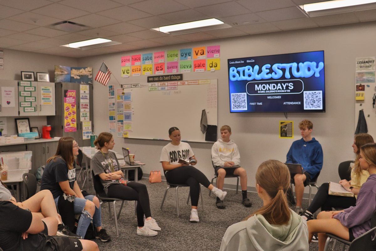 Meeting for the first time, the student-organized Bible study group listens to junior Lydia Contor read a passage from the Bible before school.