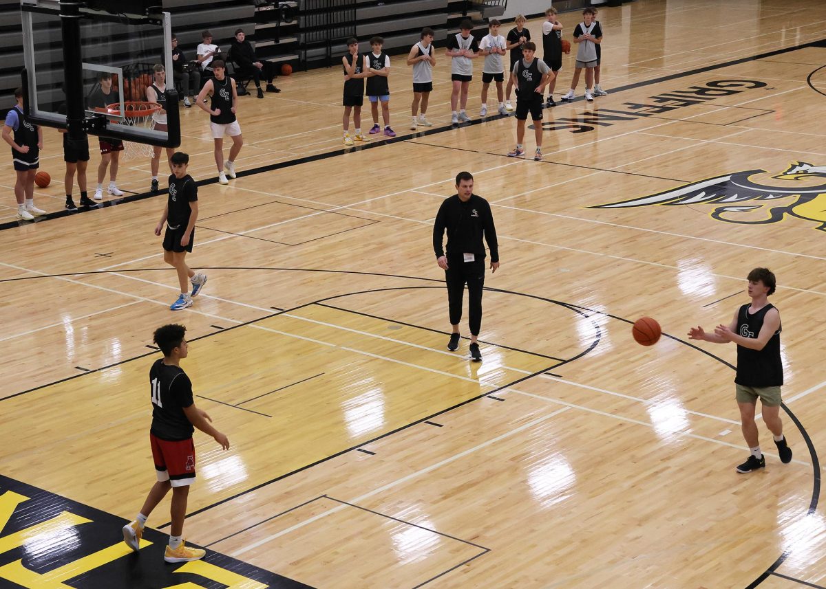 Under Boys Basketball Head Coach Cooper Anthony's direction, sophomores Drayke Brown and Jake Hawley and senior senior Tallan Hovie demonstrate a skill during practice for the rest of the team on Nov. 25.