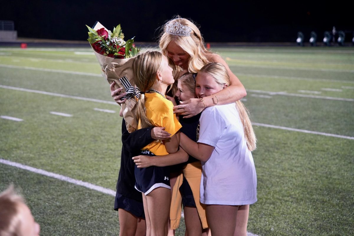 After being announced Homecoming Queen, senior Addison Larock is hugged by her sister and her friends. "I was honestly surprised, I was not expecting that at all," Larock said. "It made me feel happy that everybody thinks about me in that way."