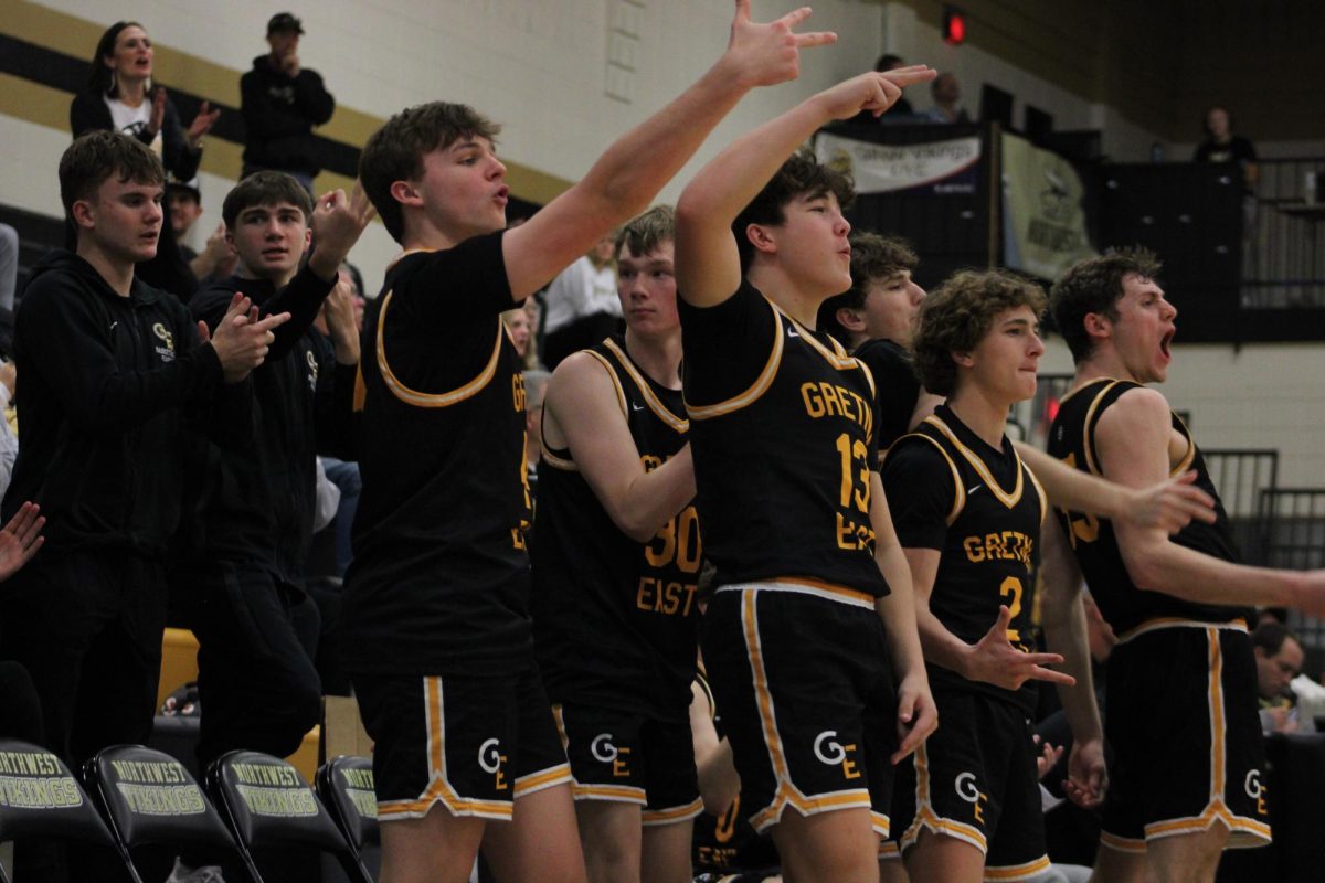 After a made three-pointer, teammates Lawson Bear (10), Brody Boone (10), Cole Edwards (12), Blake Harris (11), Lucas Winterboer (10) and Carter Craven (12) celebrate as the Griffins extend their lead.