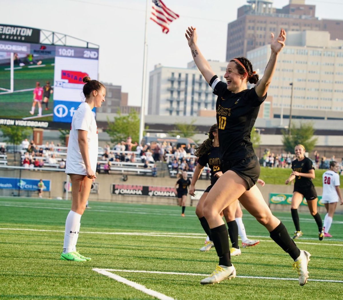 After making her 55th goal of the season and breaking the All-State record for most goals in a single season, Sonora DeFini jumps up with her arms in the air as she runs toward teammate Kendall Dobberstein during the NSAA Class B Girls Soccer State Championship game on May 13. The team ended up beating Duchesne 6-1 to become the 2024 State Champions. 