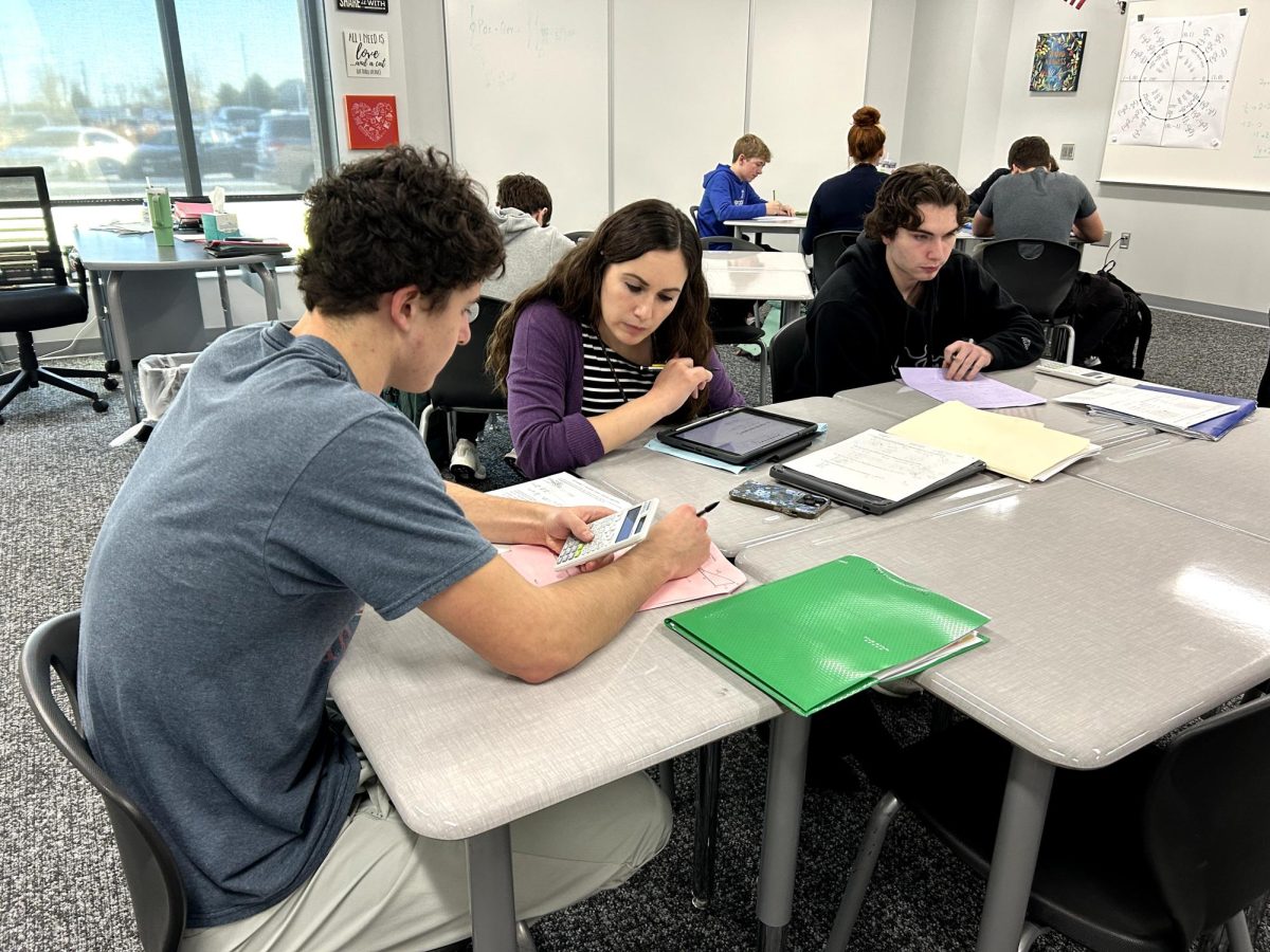 Visiting the math center after school, senior Asher Siskow gets help from math teacher Lauren Michal on his homework assignment for his Calculus 1 class. According to Michal, there was an average, 10-15 students who visited the center each week. "Centers are a good way for students to get more one-on-one help from teachers.  It can also be a good opportunity to get caught up on work," Michal said. "Even if a student's teacher is not available, there are other math teachers there who are ready to help, which is a huge benefit."