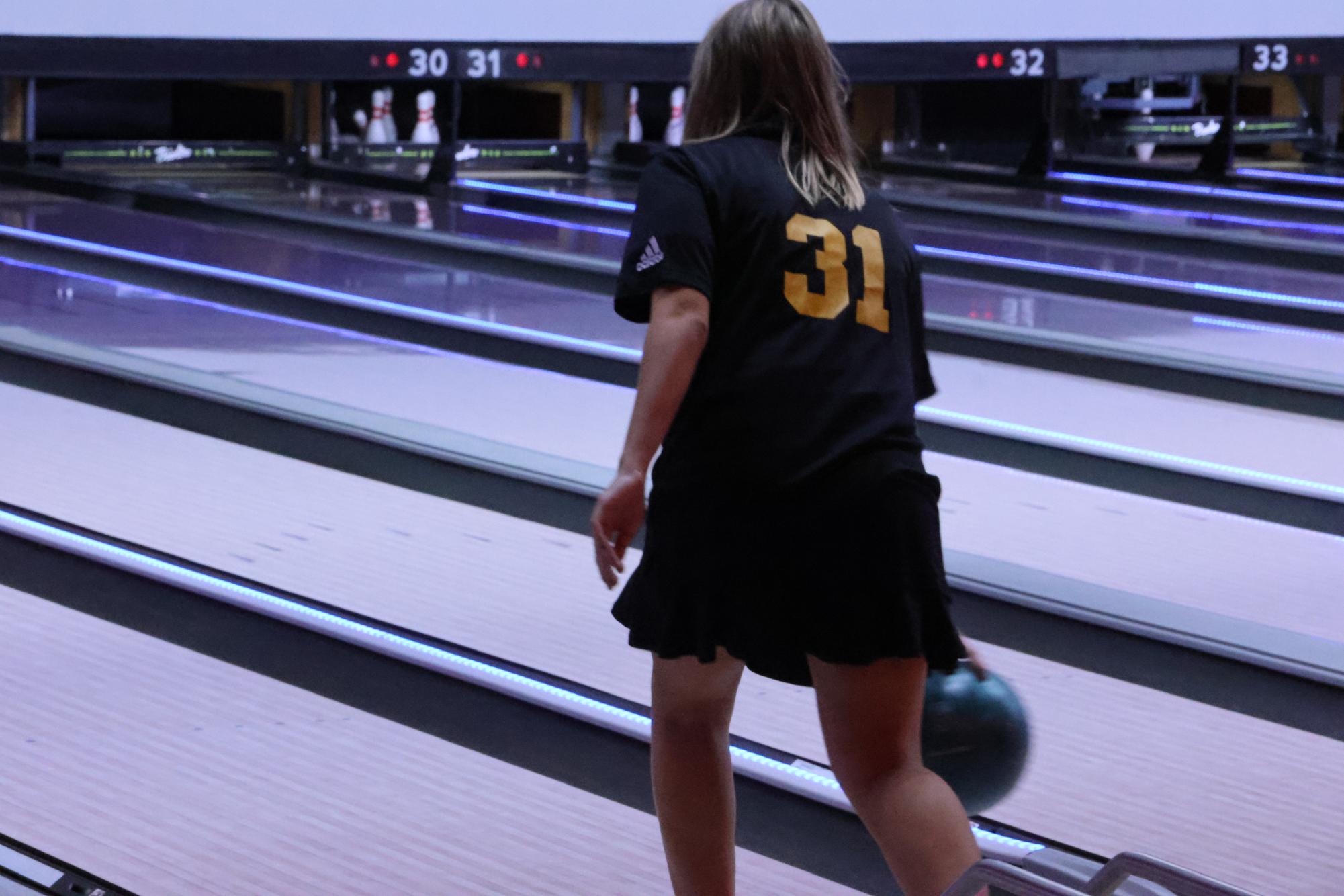 As freshman Elizabeth Reiser tries for a spare, she releases her bowling ball during practice. She knocked down two more pins, but missed the spare.