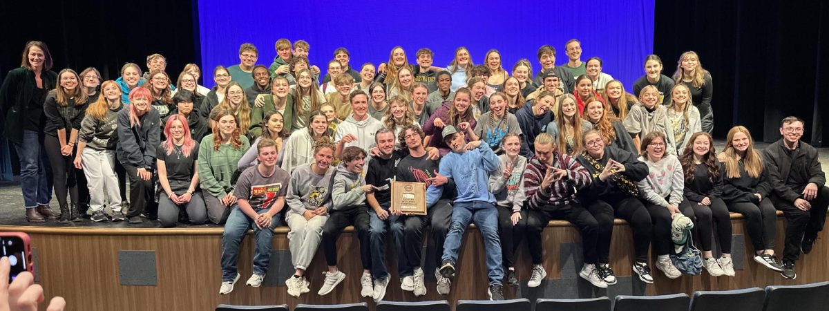 Following their Eastern Midlands Conference win on Nov. 25, the One Act cast and crew for "The Strange Case of Dr. Jekyl and Mr. Hyde" gather onstage for a group photo with their championship plaque.