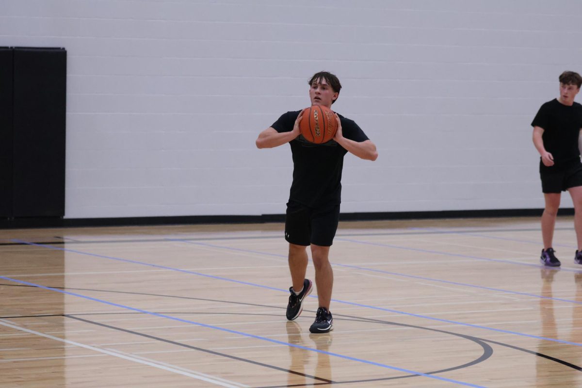 During his teams first intramural basketball game of the day, junior Jensen Albers looks to pass the ball up the floor to an open teammate. 