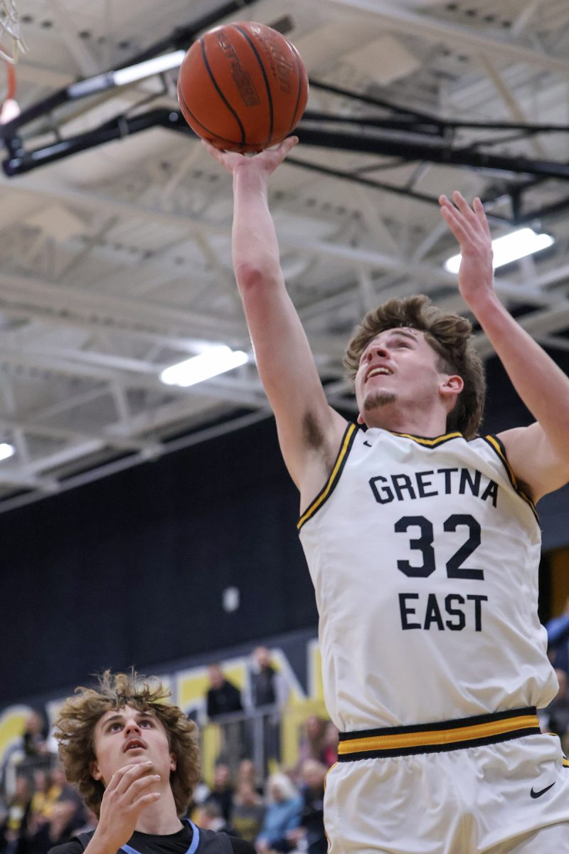 After getting past sophomore Parker Fellers, senior Grant Rice goes up for a layup during the home game against Lincoln Standing Bear on Feb. 7. Rice contributed nine points to the Griffin's 70-51 winning score. This was the boys' third win of a six-game winning streak to close out the regular season.