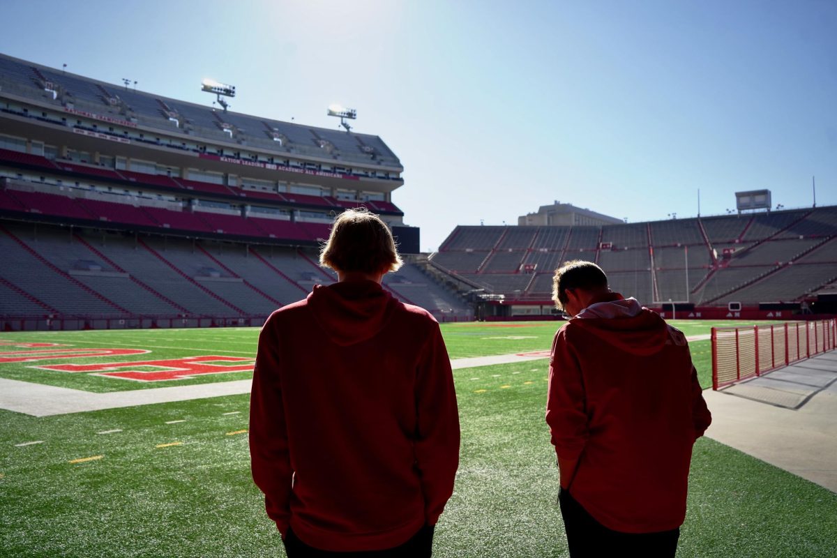 Walking with Husker Vision Tyler Rice, Brody Heidemann makes his way onto the field. 