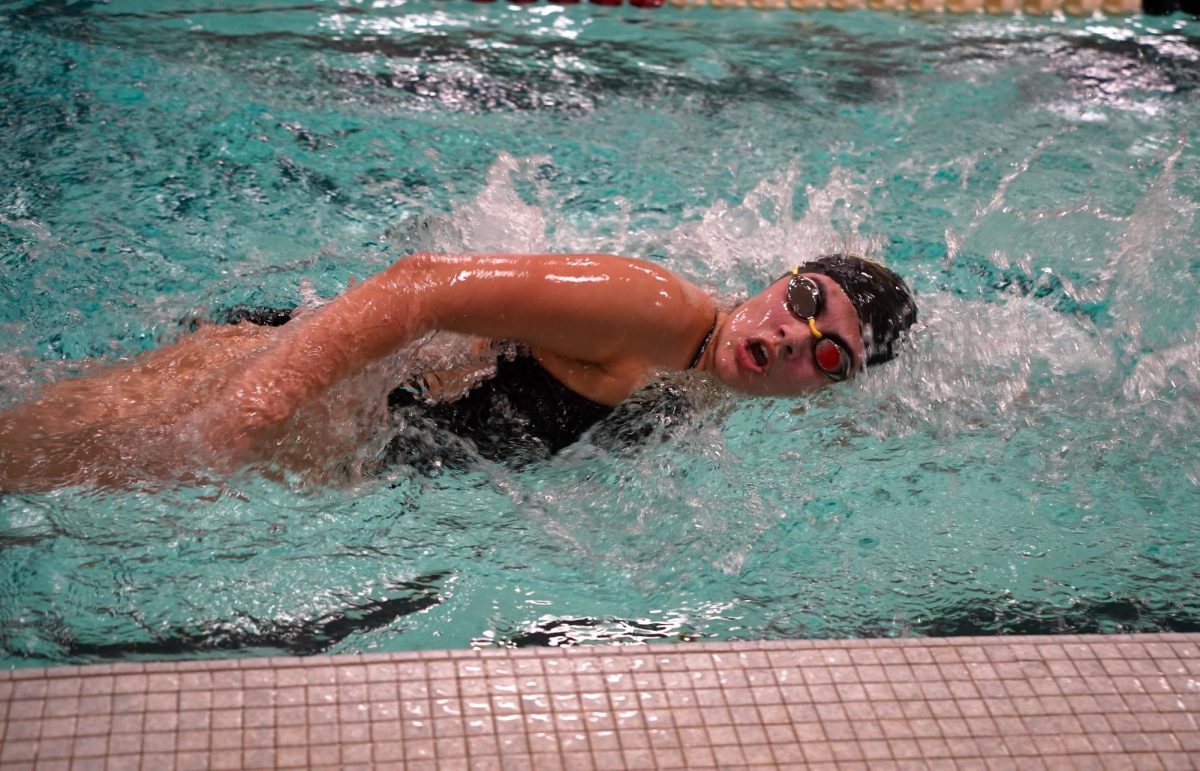 Taking a breath, freshman Aliah Cruz swims the 200 Yard Freestyle against Omaha South on Jan. 7.