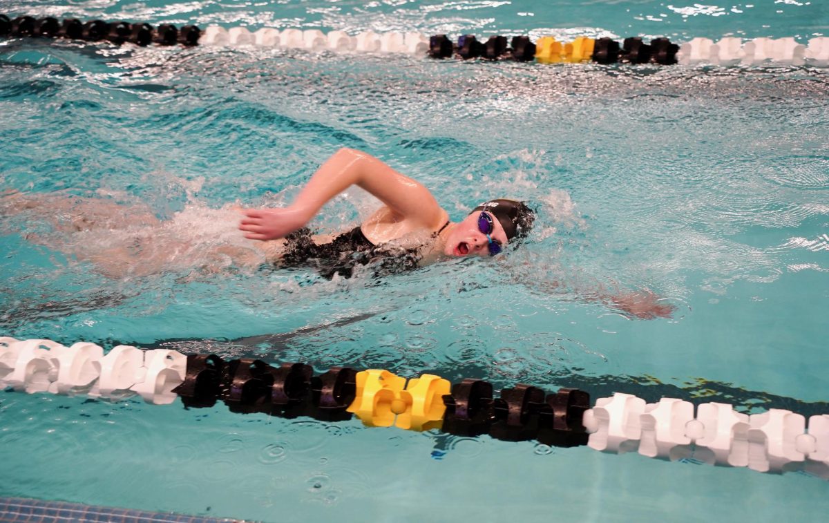 Competing in the 200 Yard Freestyle, sophomore Caitlin Rischling takes a breath. 