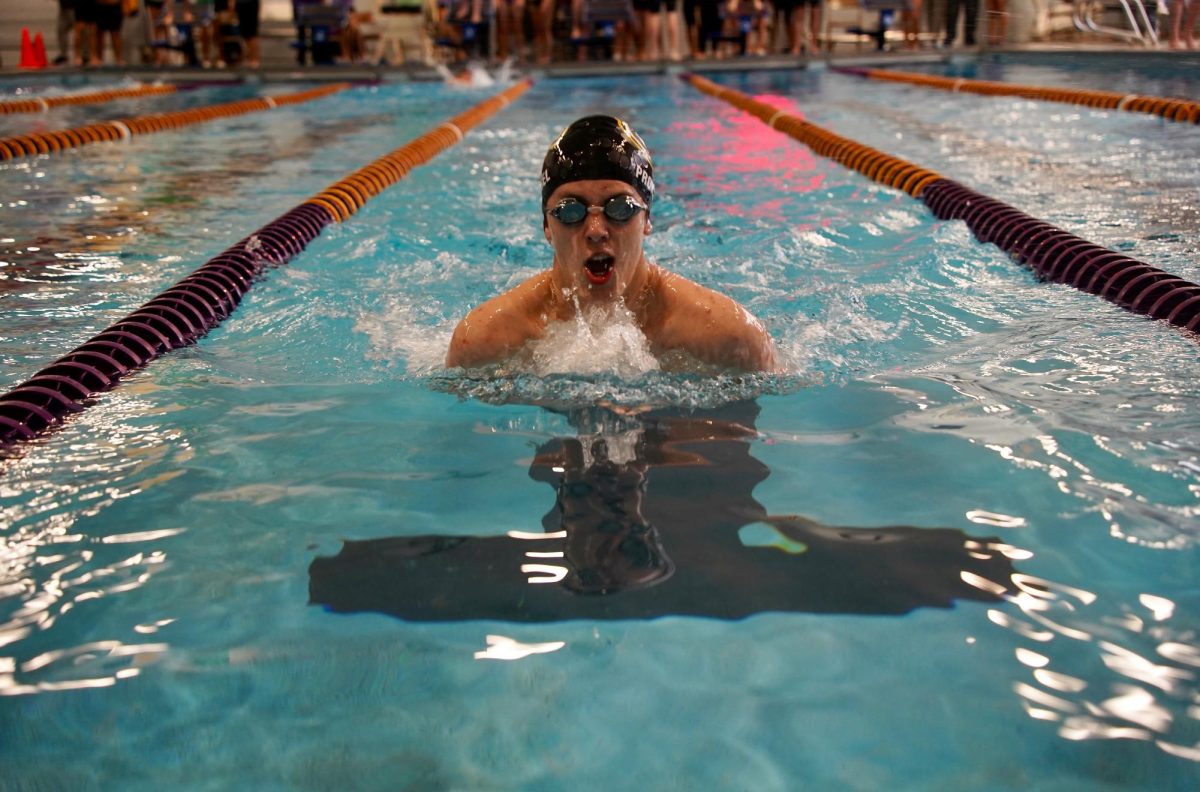 Gliding forward, junior Nicholas Proksel swims the breaststroke portion of the 200 Individual Medley at Grand Island on Jan. 21.