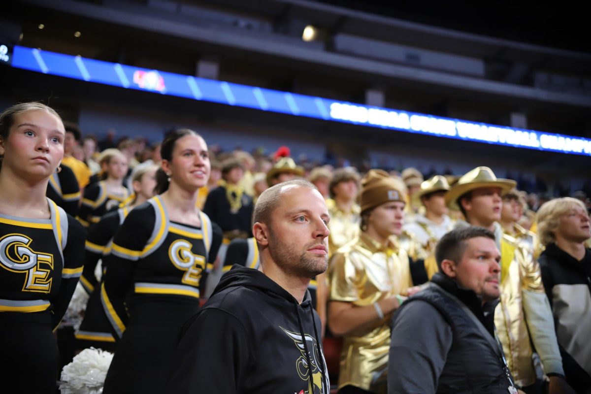 Watching the game, Athletic Director Ryan Garder stands in front of the student section at the Class B State Volleyball Semifinals on Nov. 11, 2023.