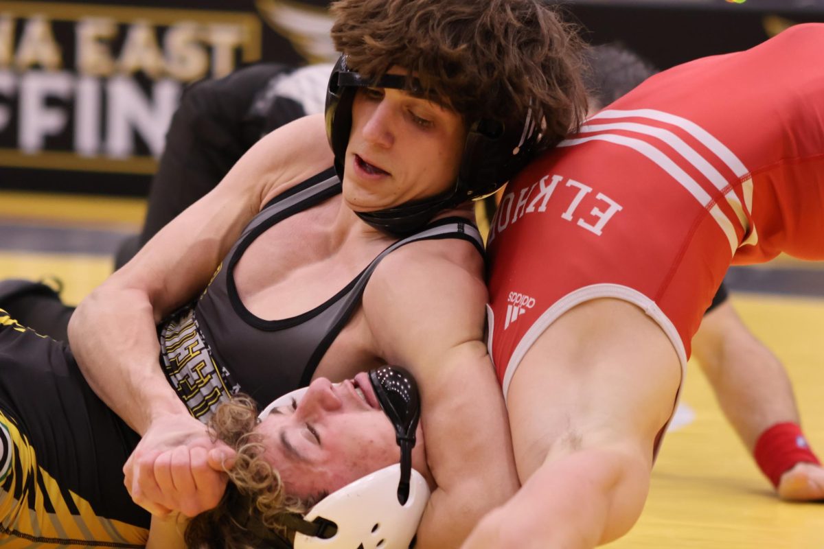 Looking down at Elkhorn's Eric Sutton, as he holds him in a headlock, junior Gabriel Campos fights his way to a pin in the last minute of the match.