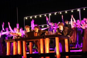 Ending their second number, "Thomas Edison" and "Weird Science," Equinox smiles out at their audience during their finals performance at the Gretna Primetime show choir competition on Jan. 18.