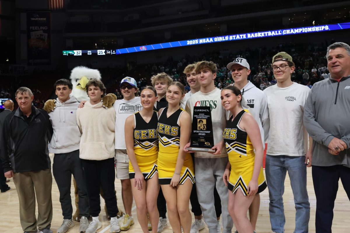 Posing for photos, Griffin students and cheerleaders hold the Currency Class B Sportsmanship Award after the State finals. 