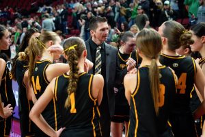 Huddled after their championship loss to Skutt Catholic, head coach Wade Coulter gives a final speech to the team before they received their runner-up medals. 