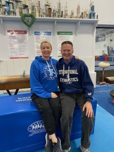John Carda poses for a photo with Svetlana Boginskaya, a three-time Olympic all-around champion.